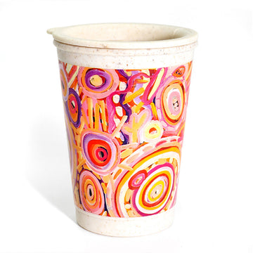 A bamboo travel mug printed with artwork by Cedric Varcoe in pinks and yellows.