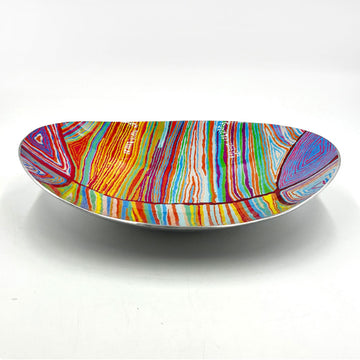 A long oval shaped stainless steel bowl printed with artwork by Judy Watson inside.