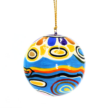 A Christmas bauble printed with artwork by Judy Watson in blue and yellow.