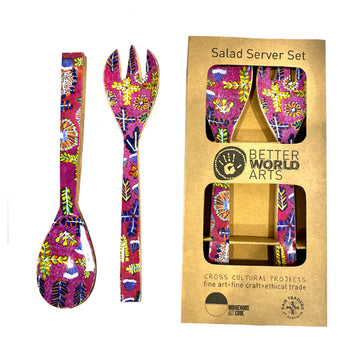 A set of wooden salad servers printed with artwork by Rosie Ross in pink. One set is picture on the left and a second set is pictured on the right inside a brown box.