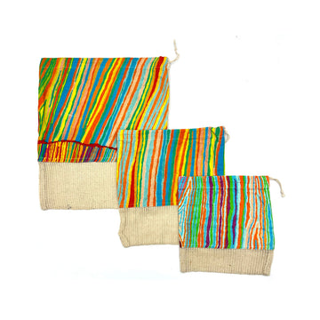 Three different sized product bags with artwork by Judy Watson printed on the top two thirds of the bag and a hessian fabric on the bottom third.