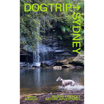 'Dog Trip Sydney' book cover featuring a photo of a waterfall with trees and a river. There is a dog standing in the water.