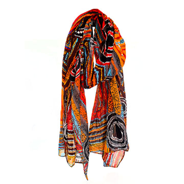 A cotton scarf printed with artwork by Mary Napangardi Brown in yellow, blue and black.
