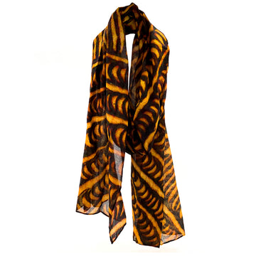 A cotton scarf printed with artwork by Cynthia Burke in yellow and brown.