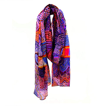 A cotton scarf printed with artwork by Nora Nyutjanka Davidson in purple and blue.