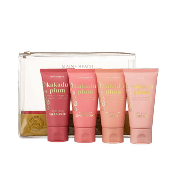 Four tubes in various shades of pink in front of a clear cosmetic bag.