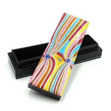 A black empty pencil box is pictured with its lid laying diagonally cross the bottom. The lid is printed with artwork by Liddy Walker.