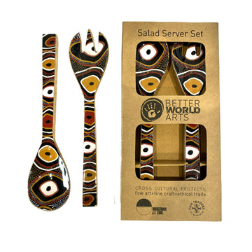 A set of wooden salad servers printed with artwork by Nina Puruntatmeri in brown. A second set of servers are pictured inside a brown box.