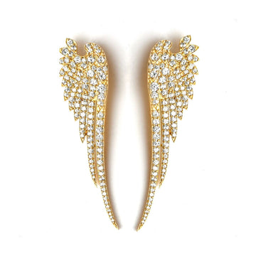 A pair of long drop earrings in gold in the shape of wings with white diamonties on top. 
