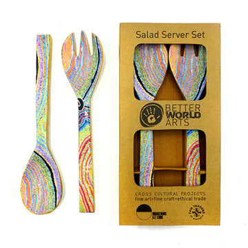 A pair of wooden salad servers printed with artwork by Liddy Napanangka Walker on the front. A pair of salad servers is pictured on the left and another pair is pictured on the right inside a cardboard box.