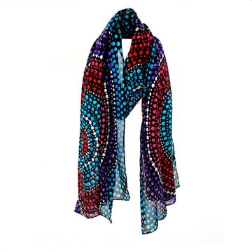 A cotton scarf printed with artwork by Olivia Wilson in blue, red and purple dots.