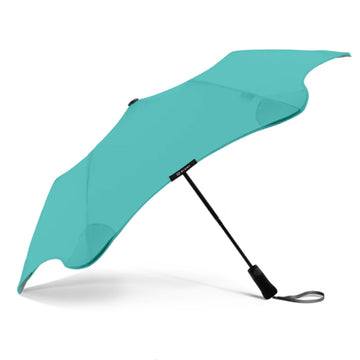 An open umbrella in a mint colour with a black handle is on a white background.