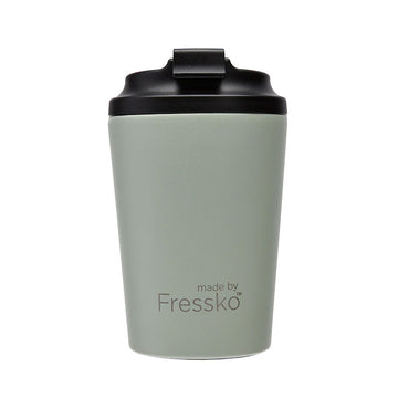 A reusable coffee cup in sage green with a black lid and the text 'made by Fressko' written on the front.