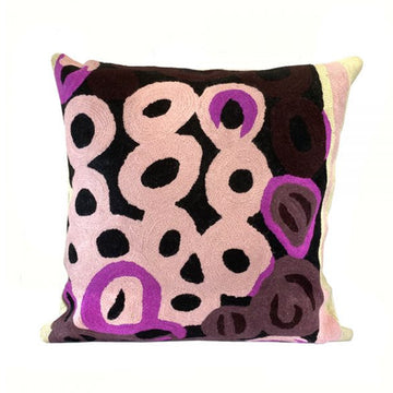 Woven woollen, zippered cushion cover 40cm x 40cm, stitched onto cotton base. Artwork by Anmanari Brown. Black background; pink, magenta, deep maroon circles. Cream, pink stripe at edge.