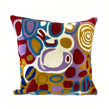 Woven woollen, zippered cushion cover 40cm x 40cm, stitched onto cotton base. Artwork by Anmanari Brown. Circular shapes and symbols. Bright yellow ochre, purple, red, blue, white.