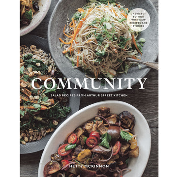 'Community' book cover featuring a top down view of three different salads on a table.