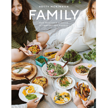 'Family' book cover featuring a photo of people sitting on the floor suurrounding different plates of food.