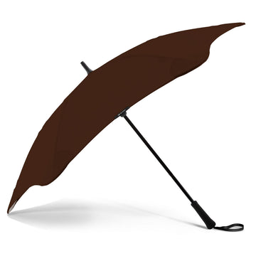 An open brown umbrella resting on its black handle.