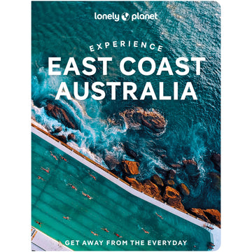 'Experience East Coast Australia' book cover featuring a top down view of a pool with people swimming in it next to the ocean with rocks.