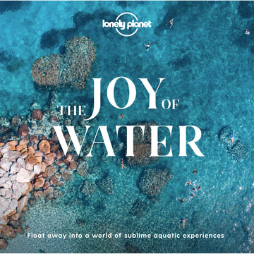 'The Joy of Water' book cover featuring a top down view of the ocean with clear blue water, rocks, and peopole swimming.