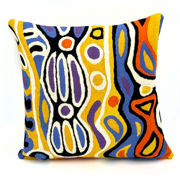 A cushion made with a chain stitch method and printed with artwork by Judy Watson in yellow, blue and black.