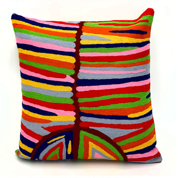 A square cushion made using a chain stitch method and printed with artwork by Judy Watson in different colours.