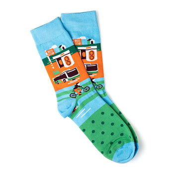 A pair of socks laying one on top of the other. They are printed with an image of a Canberra bus shelter, a bus and a person riding a bike.