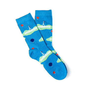 A pair of socks overlapping each other and printed with Parliament House and hot air balloons on a blue background.