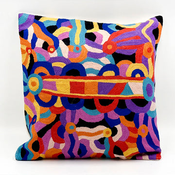A chain stitched cushion with artwork by Nora Davidson in blues, red, purples and yellows.