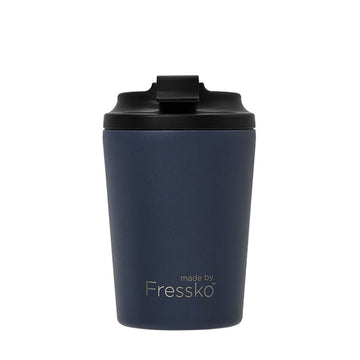 A reusable coffee cup in a denim blue with a black lid. The text 'made by Fressko' is written on the bottom of the cup.