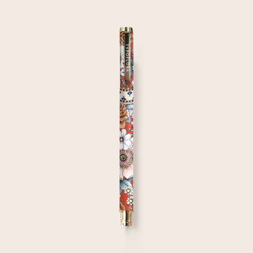 A pen printed with flowers with a gold handle and tip.