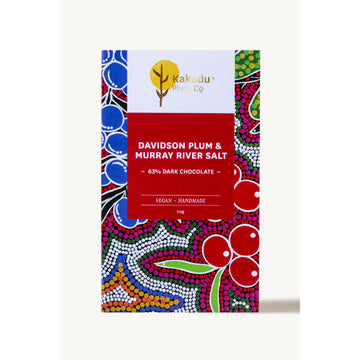 Front of a block of chocolate inside a colourful box with Aboriginal artwork and the title 'Davidson Plum & Murray River Salt 63% Dark Chocolate'.