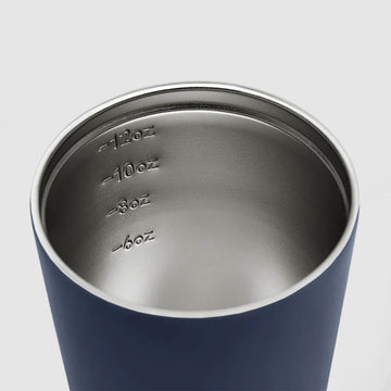 A denim blue reusable coffee cup with a black lid and the text 'made by Fressko' written on the bottom.