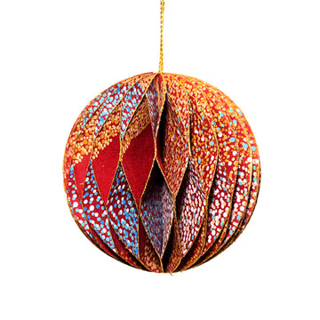 A paper christmas bauble with a honeycomb shape joining the layers and printed with artwork by Lynette Brown.