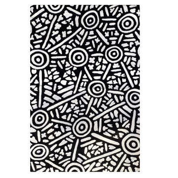 Hand woven woollen rug, 2ftx 3ft, original artwork created by Anthea Granites. Black background; white circles, lines, symbols. Depiction of Puyurru, west of Yuendumu.