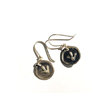 A pair of drop earrings in sterling silver featuring a circle with an embossed emu paw print.