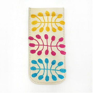A white leather glasses case embroidered with artwork by Mitjili Napurrula.