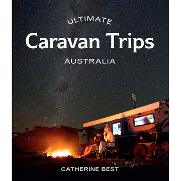 'Ultimate Caravan Trips Australia' book cover featuring a photo of two people sitting outside a caravan at night time in front of a fire with a starry sky.