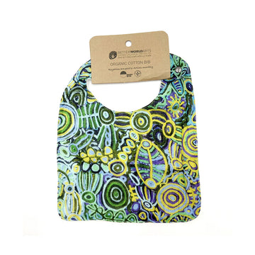 A cotton baby bib printed with artwork by Cedric Varcoe and a brown product tag at the top.