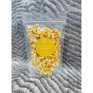 A clear bag filled with sunrise lime flavoured chips and a yellow sticker on the front that says 'Warndu Feel Good Sunrise Lime'.