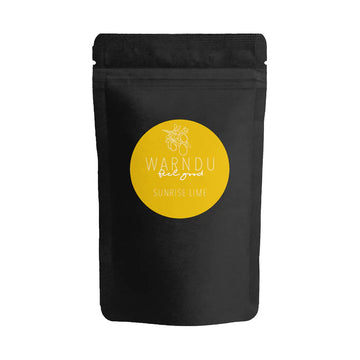 A black bag with a yellow sticker on the front with the text 'Warndu Feel Good Sunrise Lime'.