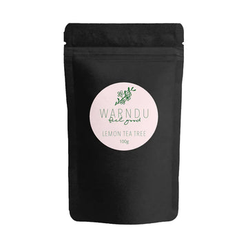 A black pouch with a light pink sticker on the front that says 'Warndu Feel Good Lemon Tea Tree'.