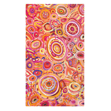 A sarong printed with artwork by Cedric Varcoe is laid out flat.