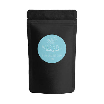 A black bag with a blue circle label on the front with the text 'Warndu Feel Good Peppermint Gum'.