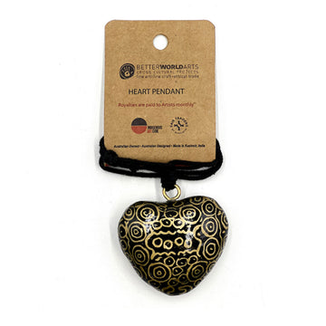 A heart shaped pendant printed with artwork by Nelly Patterson on a black cord attached to a brown product card.