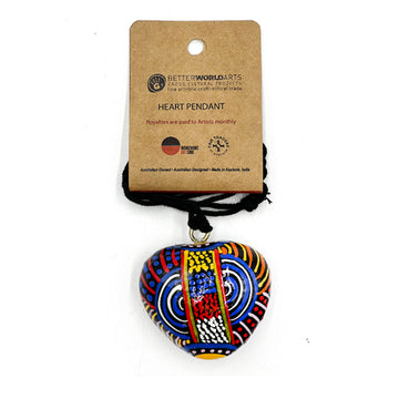 A heart shaped pendant printed with artwork by Nora Nyutjanka Davidson on a black cord attached to a brown product card.