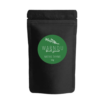 A black packet with a round green sticker on the front with the text 'Warndu Feel Good Native Thyme'.