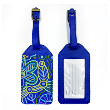 Front and back view of a luggage tag in blue with a clear sleeve on the back and embroidered with artwork by Cedric Varcoe on the front.