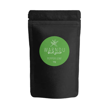 A black packet with a round green label on the front with the text 'Warndu Feel Good Pepper Leaf'.