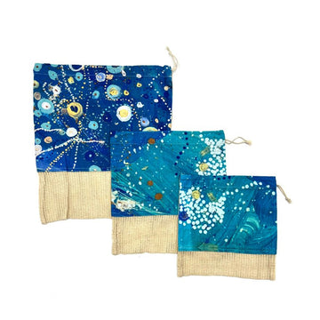 Three different size produce bags with a hessian strip on the bottom third and a cotton print by Stephen Jupurrula Nelson on the top two thirds.